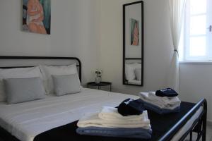 a bedroom with a bed with towels on it at Cycladic Villa in Amorgos Island (Maison Shiro) in Arkesíni