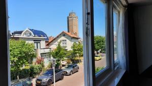 a view from a window of a street with cars at Guesthouse Zandvoort in Zandvoort