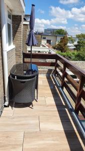 a patio with a table and an umbrella on a balcony at Guesthouse Zandvoort in Zandvoort