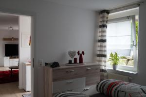 a living room with a dresser and a window at Ferienwohnung Murg Niederhof in Murg