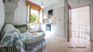 a living room with a couch and a kitchen at A & B Holiday Home in Deiva Marina