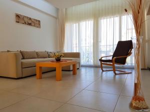 a living room with a couch and a coffee table at Odyssey Residence Apartments in Fethiye