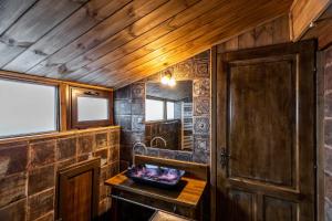 a wooden room with a wooden door and a table at Lithochoro in Litochoro