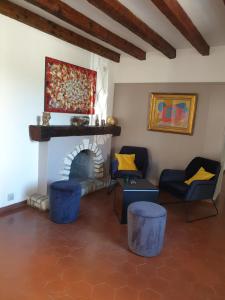 a living room filled with furniture and a fire place at Hotel Maquis et Mer in Sari Solenzara