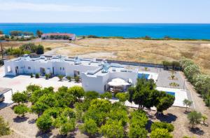 an aerial view of a white building with the ocean in the background at Aegean Horizon apartments in Gennadi