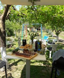 a picnic table with a plate of food on it at Kuća za odmor Mirni kutak Vukovar in Vukovar