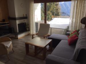 a living room with a couch and a table at Roc d'Orsay F66 in Leysin