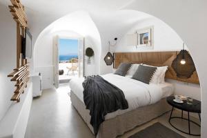 a bedroom with a bed and a view of the ocean at Casa Luz in Pyrgos +50 photos