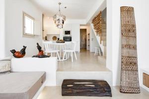a living room with a staircase and a dining room at Casa Luz in Pyrgos