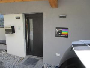 a building with a door with a sign on it at Apartment Skyline in Wenns