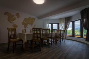 a dining room with a table and chairs at Acasa la Mariuca in Bran +86 photos