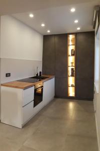 a kitchen with white cabinets and a counter top at Sunce in Primošten