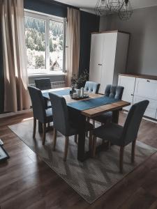 a dining room table and chairs in a kitchen at Jaszczurowa Apartament in Jaszczurowa