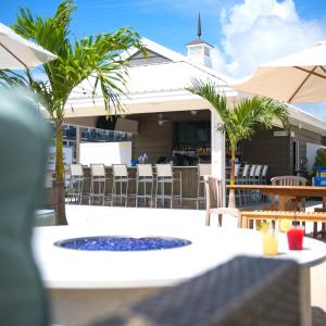 a patio with a table and chairs and a fire pit at ICONA Avalon in Avalon