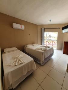 Tempat tidur dalam kamar di Hotel Brisas