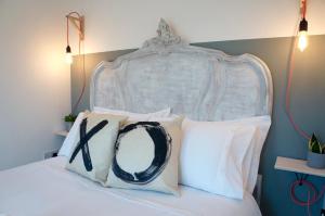 a bedroom with a white bed with white pillows at The Oldbrook Garden Flat in Milton Keynes