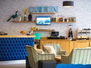 a waiting room with two chairs and a television at Carlton Hotel in Ilfracombe