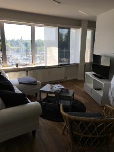 a living room with a couch and a tv at Apartment 6, OG 3 in Schleswig