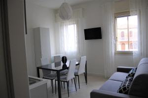 salon ze stołem, krzesłami i kanapą w obiekcie Locazione Turistica Elite Parco Brentelle bed & breakfast - Chiesanuova 135 e 167 w Padwie