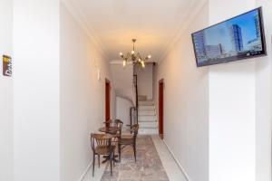 a dining room with a table and a tv on the wall at Pera Boutique Hotel in Antalya
