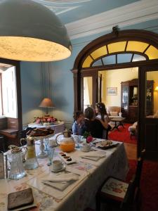 two people sitting at a table in a room at Casa d'Aldeia de Souto de Lafões OLIVEIRA DE FRADES in Oliveira de Frades