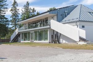 a house with a staircase in front of it at Käsmu Holiday House in Käsmu