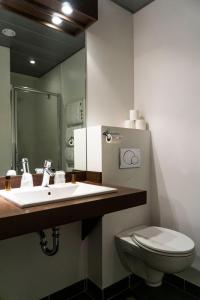 a bathroom with a sink and a toilet at Hôtel d'Ossau in Laruns