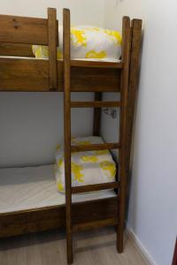 a wooden bunk bed with pillows on the bottom bunk at Hôtel d'Ossau in Laruns