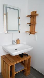 a bathroom with a white sink and a mirror at La Bergerie du Mesnil in Livry