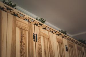 a row of wooden cabinets with plants on top of them at Domki pod Strzechą in Zakopane