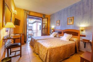 Ένα ή περισσότερα κρεβάτια σε δωμάτιο στο Hotel Retiro del Maestre