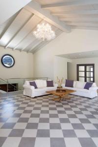 a living room with two couches and a checkered floor at Megisti Hotel in Meyisti