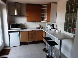 a kitchen with wooden cabinets and a counter top at Apartment Adéla in Hluboká nad Vltavou