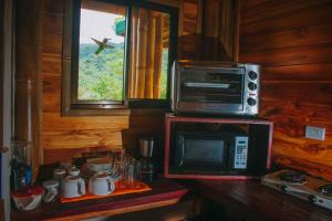 a kitchen with a microwave oven and a microwave at Bambura Hermosa villas in Uvita