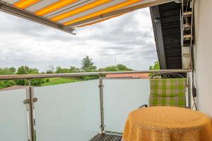 a screened in porch with a table and awning at Haus Storck in Neustadt an der Weinstraße