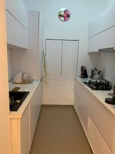 a kitchen with white cabinets and a counter top at Casa Centru in Mediaş