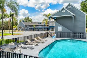 una piscina con sillas y un edificio en GatorTown Inn, en Gainesville