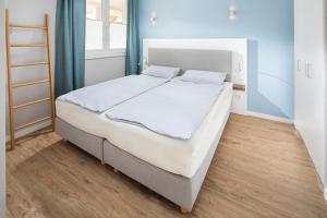 ノルダーナイにあるDüsseldorfer Hof Norderney A1のベッドルーム(白いシーツを使用した大型ベッド1台付)