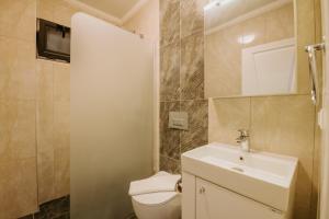 a bathroom with a white sink and a toilet at MULBERRY SUİT APART in Kaş +38 photos