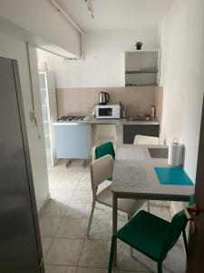uma pequena cozinha com mesa e cadeiras em green Apartment 96 em Bucareste