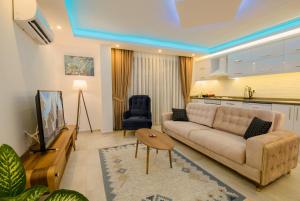 a living room with a couch and a tv at MULBERRY SUİT APART in Kaş