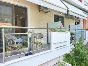 a balcony with two chairs and a table at Villa Sofia Fresh in Limenaria