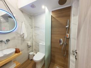a bathroom with a toilet and a sink and a mirror at Villa Sofia Fresh in Limenaria +22 photos