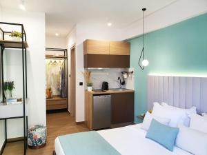 a bedroom with a bed and a kitchen in it at Villa Sofia Fresh in Limenaria