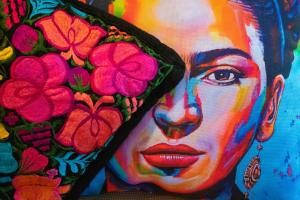 een schilderij van een vrouw met bloemen aan de muur bij Hotel Posada De Roger in Puerto Vallarta