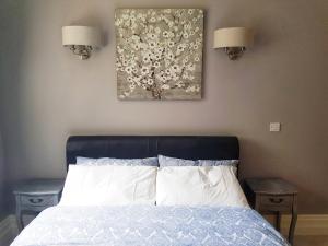 a bedroom with a bed and a painting on the wall at Elegantly Restored Suite in Historic Limerick in Limerick