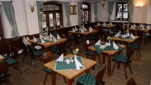 a dining room with wooden tables and chairs at Wirtshaus zum Baumbach in Aschau im Chiemgau