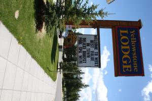 a sign hanging from the side of a building at Yellowstone Lodge in West Yellowstone