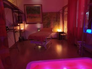 a room with a bed in a room with pink lights at B&B Cà d'Artisti in Caorle