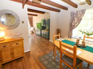 a kitchen and dining room with a table and chairs at Bilberry Nook Cottage in Westgate